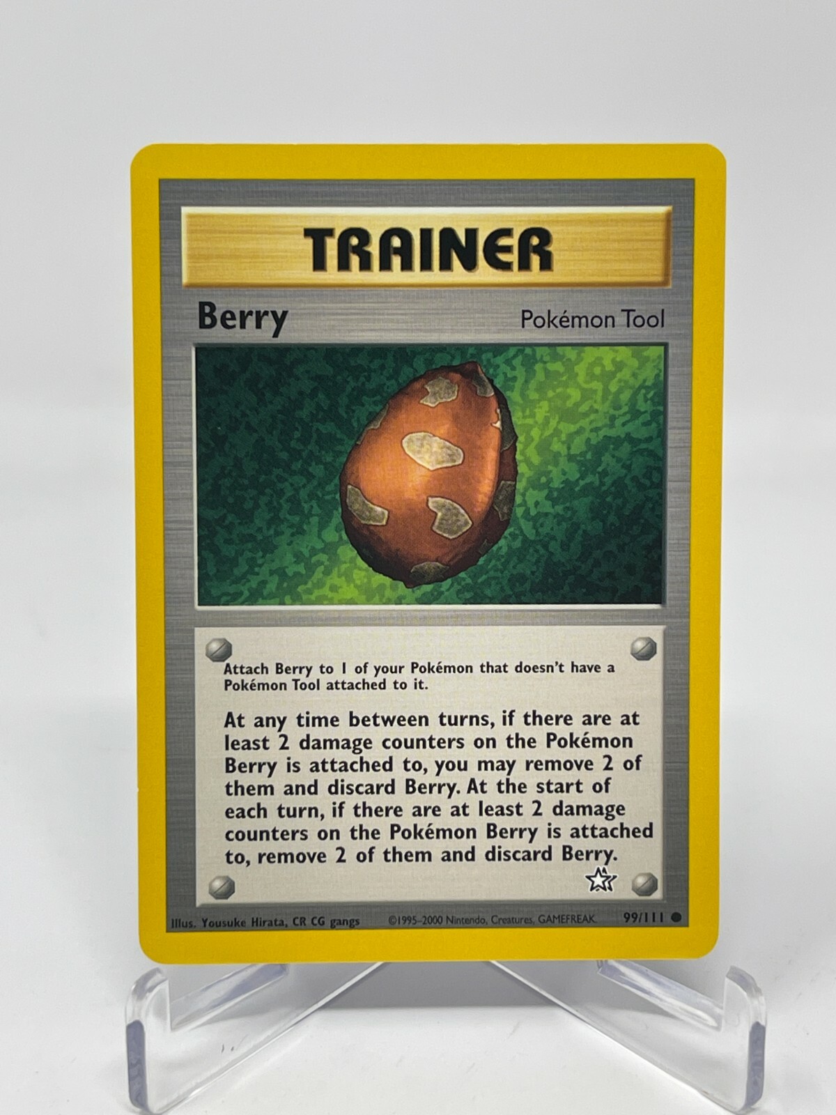 The physical Berry card, Neo Genesis 99/111, on a clear acrylic stand
